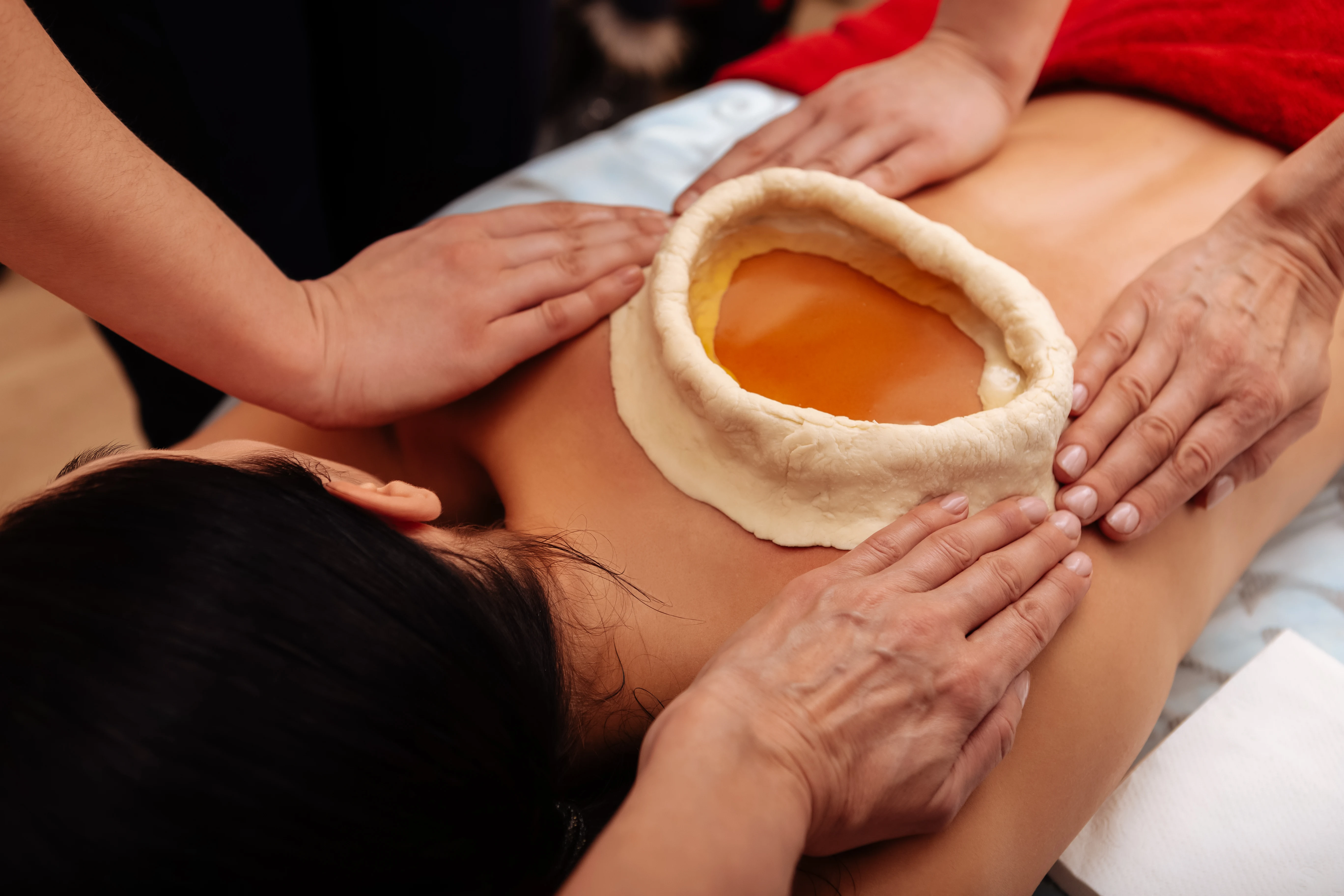 Warm oil therapy applied to the lower back to reduce stiffness, ease muscle spasms, nourish the spine, improve mobility, and provide lasting relief, especially beneficial for chronic lower back pain and sciatica.
